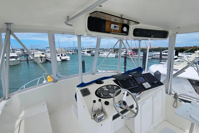 Slide: The Image of Cockpit view of 2000 Ocean Yachts 40 Super Sport at marina, showcasing helm controls. - 30