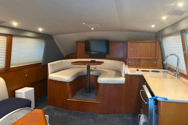 Slide: The Image of Interior of 2000 Ocean Yachts 40 Super Sport with seating, kitchen, and TV. - 34