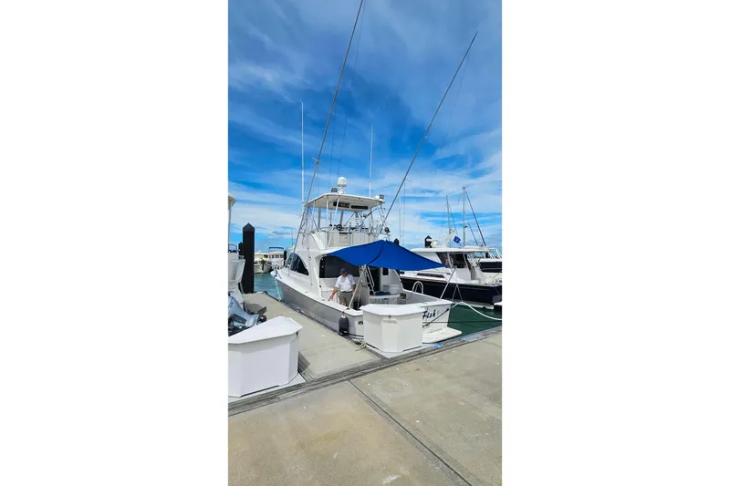 Slide: The Image of 2000 Ocean Yachts 40 Super Sport docked at marina under clear blue sky. - 4