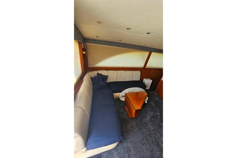 Slide: The Image of Interior of 2000 Ocean Yachts 40 Super Sport with plush seating and wooden table. - 43