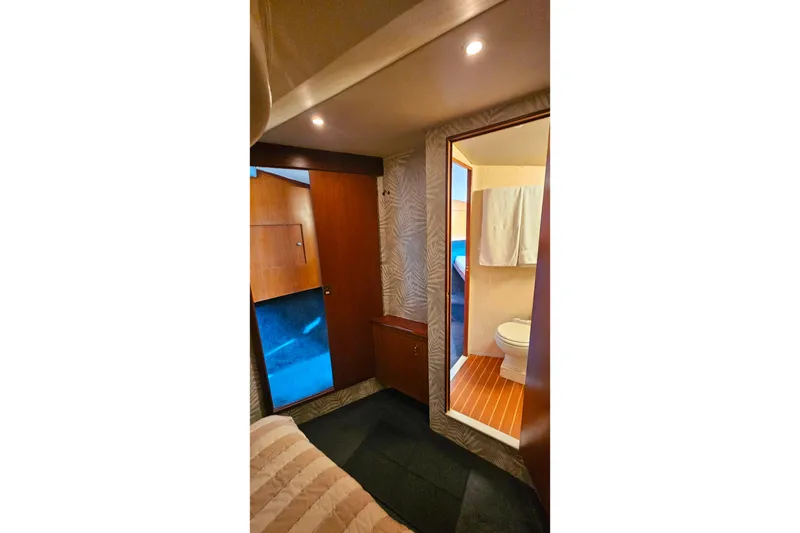 Slide: The Image of Interior of 2000 Ocean Yachts 40 Super Sport, featuring a cozy cabin and bathroom. - 48