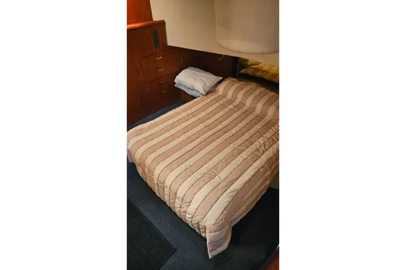 Slide: The Image of Cozy bedroom interior of 2000 Ocean Yachts 40 Super Sport with striped bedding. - 49