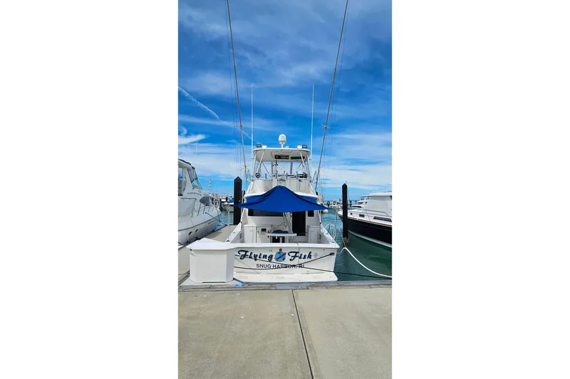Slide: The Image of Ocean Yachts 40 Super Sport 2000 docked at marina under clear blue sky. - 5