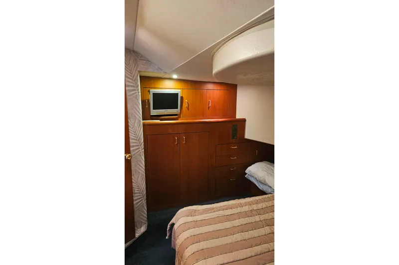 Slide: The Image of Interior cabin of 2000 Ocean Yachts 40 Super Sport with TV and wooden cabinetry. - 52