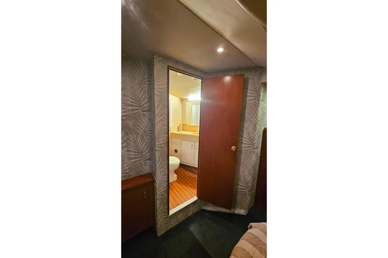 Slide: The Image of Interior view of 2000 Ocean Yachts 40 Super Sport bathroom with wooden door and modern fixtures. - 53