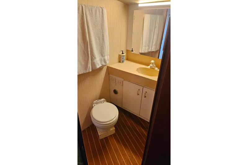 Slide: The Image of Bathroom interior of 2000 Ocean Yachts 40 Super Sport with wooden flooring and vanity. - 55