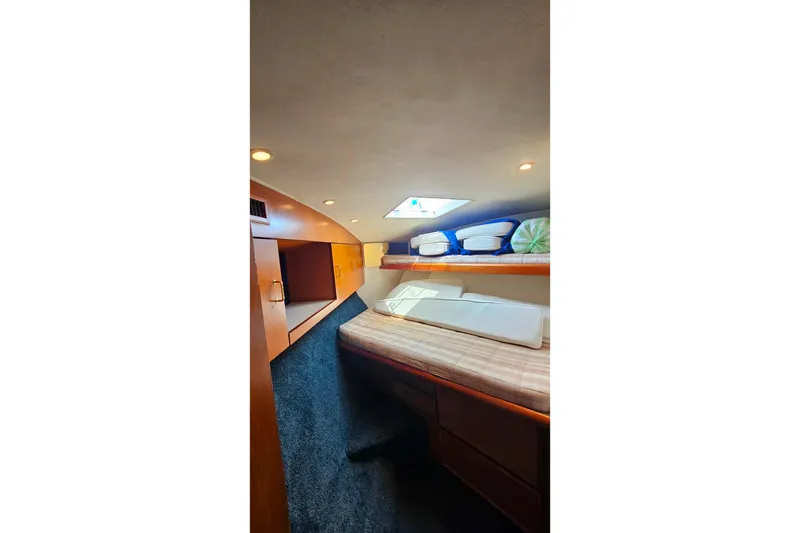 Slide: The Image of Interior cabin of 2000 Ocean Yachts 40 Super Sport, featuring cozy bedding and storage. - 58