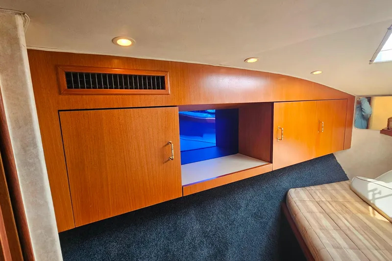 Slide: The Image of Interior of 2000 Ocean Yachts 40 Super Sport with wooden cabinetry and blue lighting. - 61