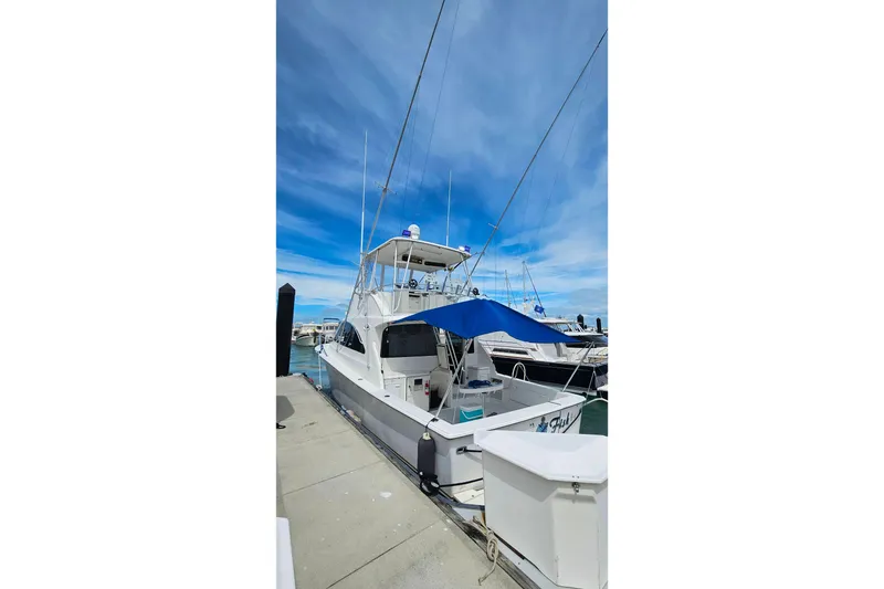 Slide: The Image of Ocean Yachts 40 Super Sport 2000 docked under a clear blue sky. - 7