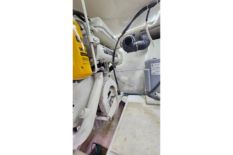 Slide: The Image of Engine room of 2000 Ocean Yachts 40 Super Sport, showcasing mechanical components. - 77