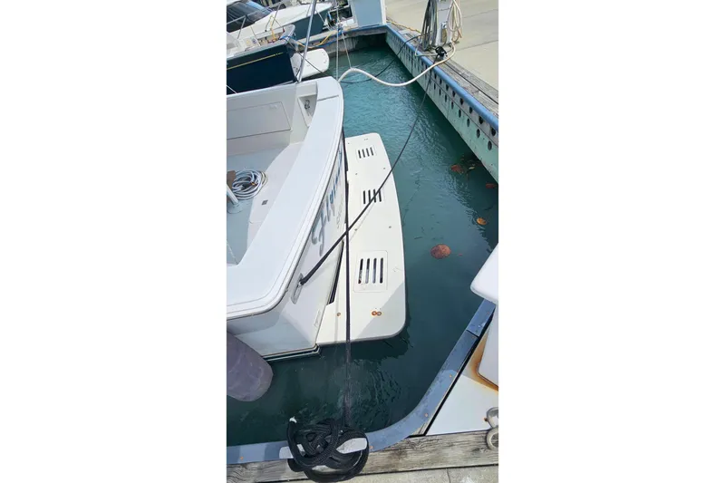Slide: The Image of Docked 2000 Ocean Yachts 40 Super Sport with swim platform and mooring lines. - 8