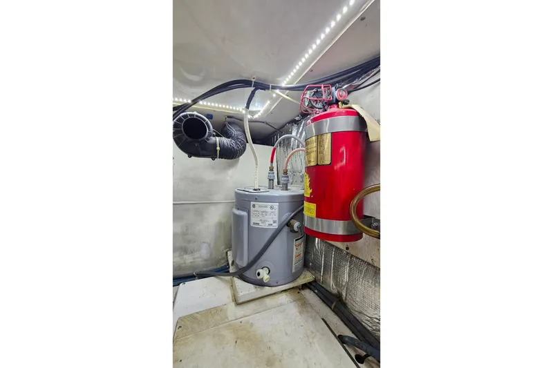 Slide: The Image of Engine room of 2000 Ocean Yachts 40 Super Sport with equipment and fire extinguisher. - 80