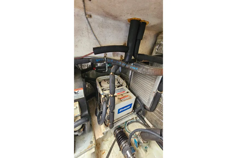 Slide: The Image of Engine room of 2000 Ocean Yachts 40 Super Sport with mechanical components and wiring. - 82