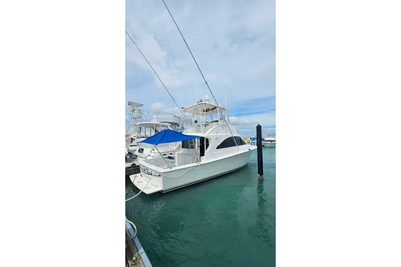 Slide: The Image of 2000 Ocean Yachts 40 Super Sport docked in marina with blue canopy. - 83