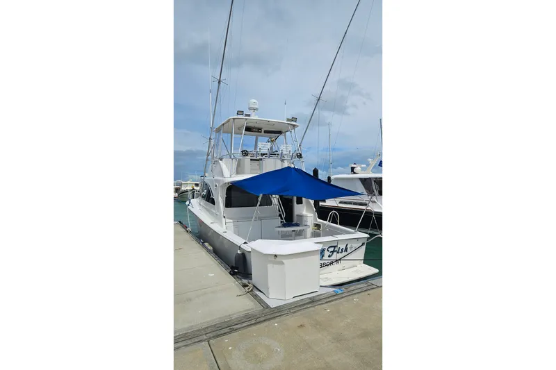 Slide: The Image of 2000 Ocean Yachts 40 Super Sport docked at marina with blue canopy. - 85