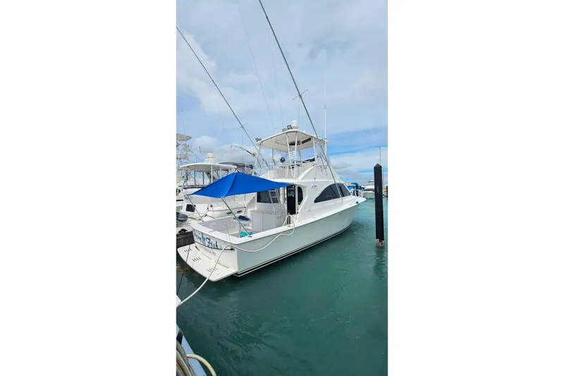 Slide: The Image of Ocean Yachts 40 Super Sport 2000 docked, featuring a sleek design and blue canopy. - 86