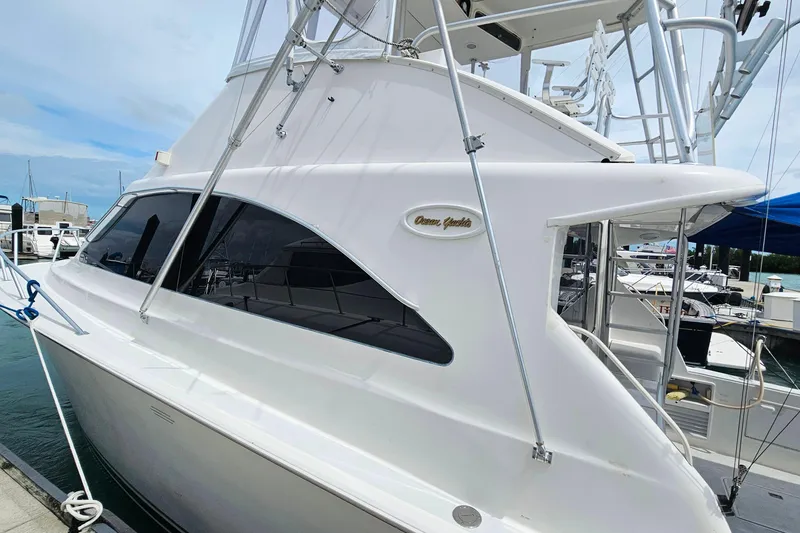 Slide: The Image of 2000 Ocean Yachts 40 Super Sport docked at marina, showcasing sleek design. - 87