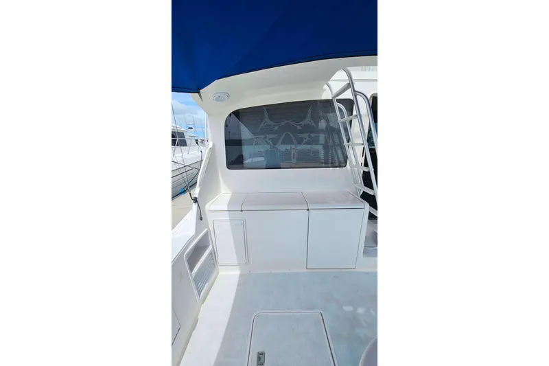 Slide: The Image of 2000 Ocean Yachts 40 Super Sport yacht interior with blue canopy and storage compartments. - 88