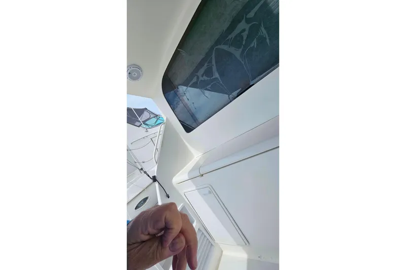 Slide: The Image of Interior view of a 2000 Ocean Yachts 40 Super Sport boat, featuring a hand gesture. - 89