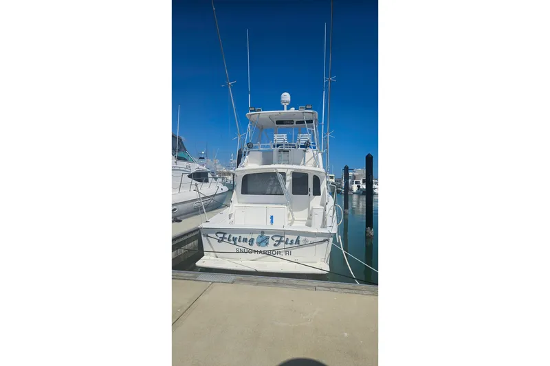 Slide: The Image of 2000 Ocean Yachts 40 Super Sport docked at marina under clear blue sky. - 93