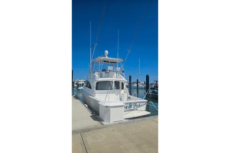 Slide: The Image of 2000 Ocean Yachts 40 Super Sport docked at marina under clear blue sky. - 94