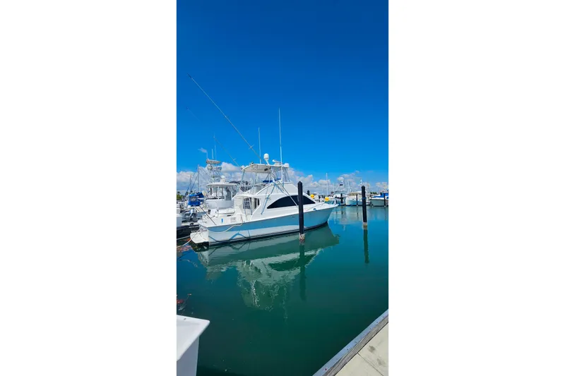 Slide: The Image of Ocean Yachts 40 Super Sport 2000 docked in a marina under clear blue skies. - 95