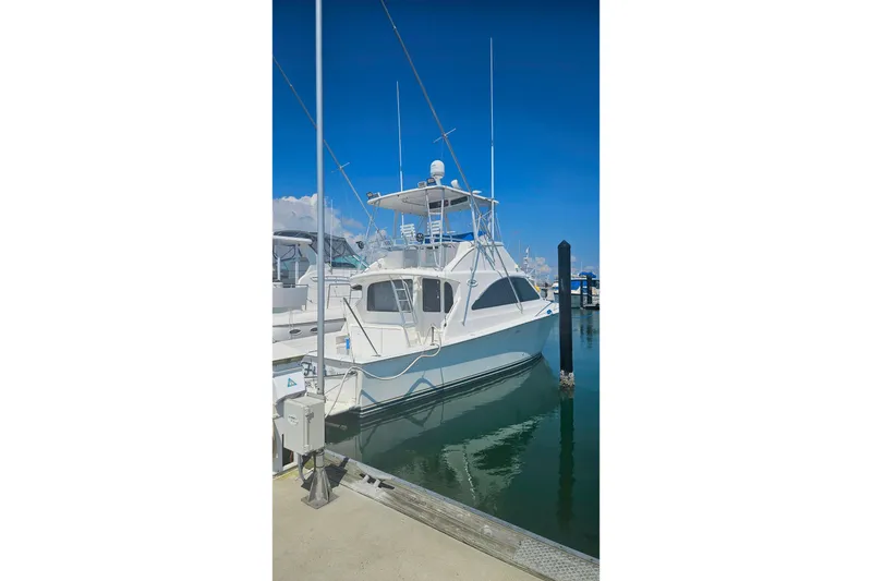 Slide: The Image of Ocean Yachts 40 Super Sport 2000 model docked at marina under clear blue sky. - 96