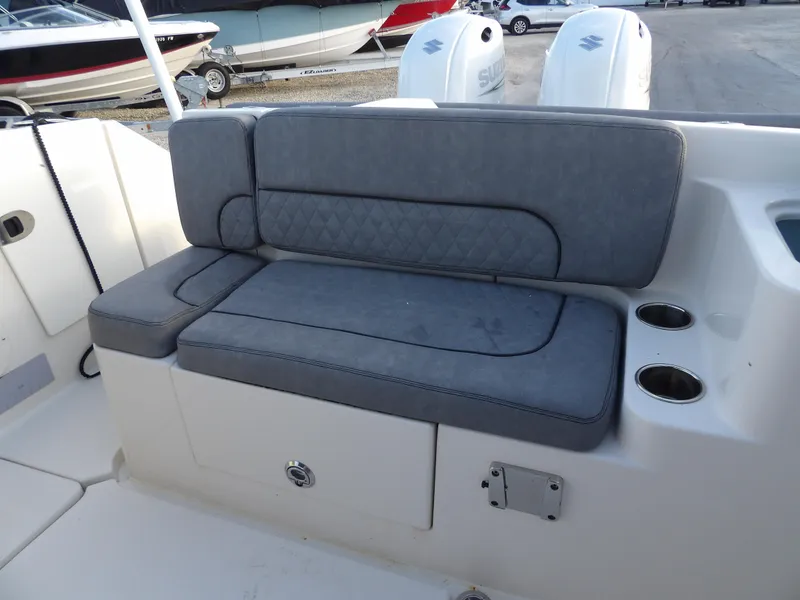 Slide: The Image of 2022 Stingray 269 DC boat with gray cushioned seating and cup holders. - 16