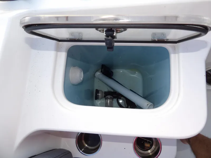 Slide: The Image of Livewell compartment in 2022 Stingray 269 DC boat, featuring storage and cup holders. - 23