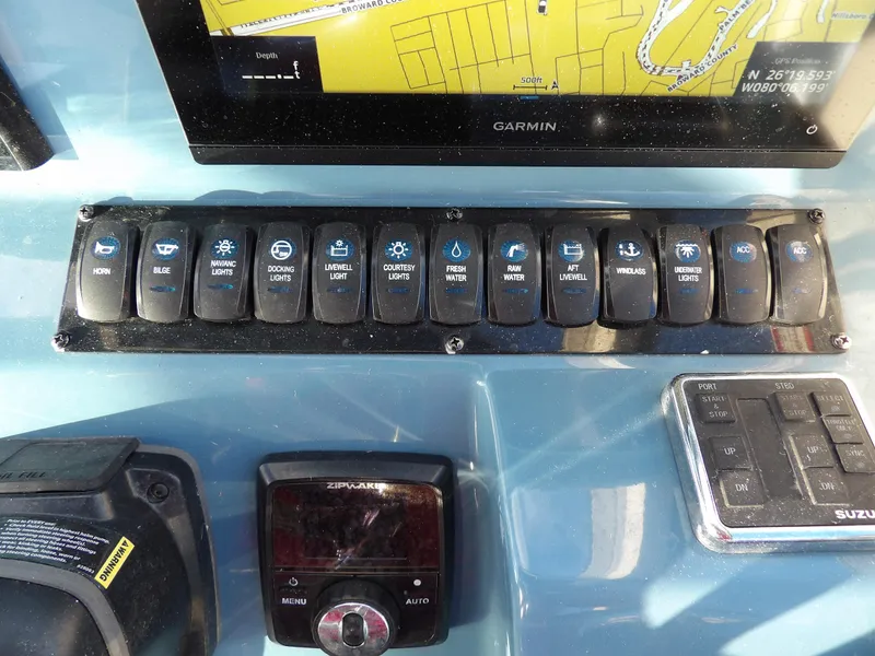 Slide: The Image of Control panel of a 2022 Stingray 269 DC boat with various switches and a Garmin display. - 30