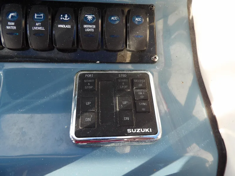 Slide: The Image of Control panel of a 2022 Stingray 269 DC boat with Suzuki controls. - 32