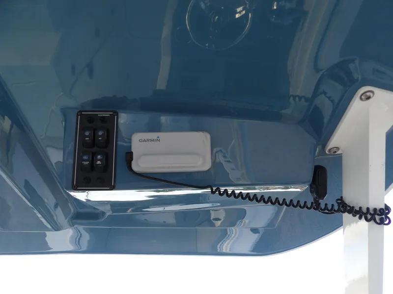 Slide: The Image of 2022 Stingray 269 DC boat dashboard with Garmin device and control panel. - 33