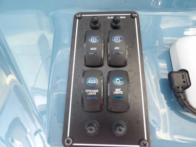 Slide: The Image of Control panel of a 2022 Stingray 269 DC boat with switches for lights and accessories. - 34