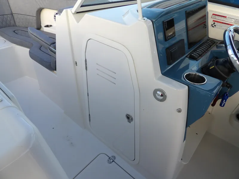 Slide: The Image of 2022 Stingray 269 DC boat interior with control panel and seating area. - 42