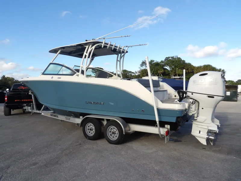 Slide: The Image of 2022 Stingray 269 DC boat on trailer, featuring sleek design and powerful outboard motor. - 5