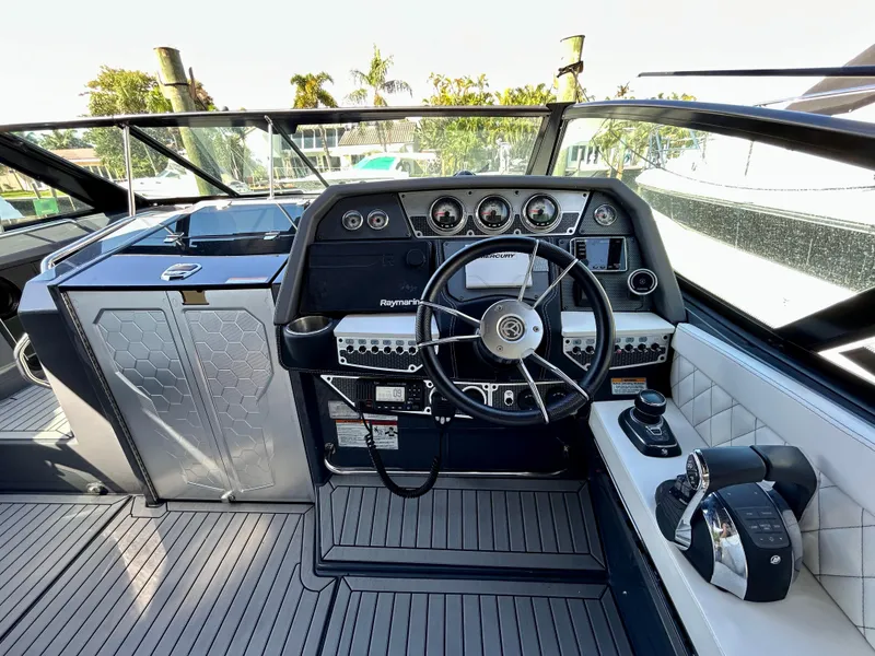 Slide: The Image of 2021 Cruisers Yachts 338 South Beach Edition Bow Rider helm with modern controls and sleek design. - 21