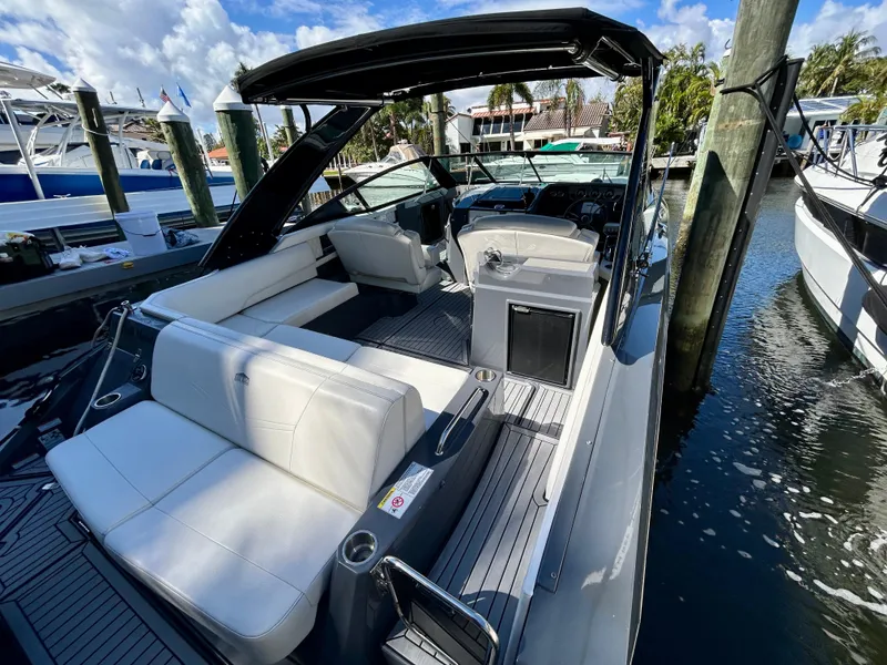 Slide: The Image of 2021 Cruisers Yachts 338 South Beach Edition Bow Rider docked, featuring sleek design and spacious seating. - 37