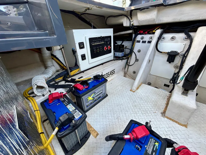 Slide: The Image of 2021 Cruisers Yachts 338 South Beach Edition engine compartment with batteries and control panel. - 46