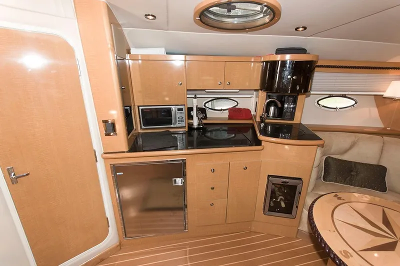 Slide: The Image of Interior of 2009 Larson Cabrio 330 Day Cruiser with kitchen and seating area. - 14