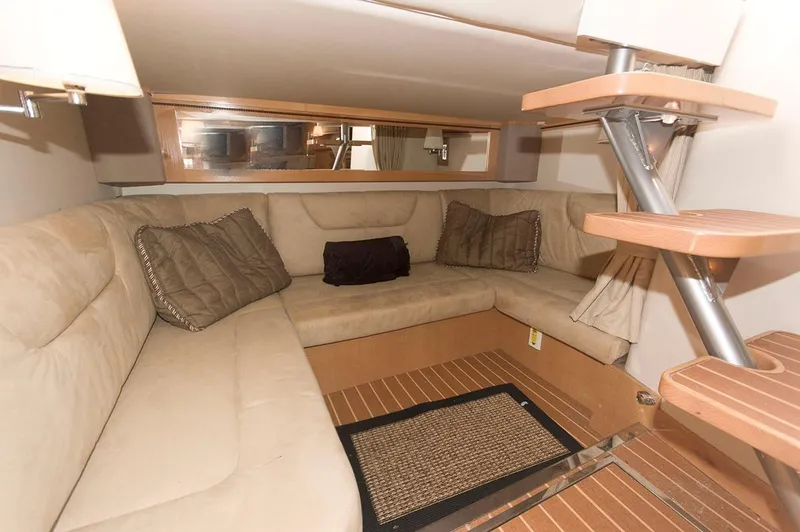 Slide: The Image of Interior of 2009 Larson Cabrio 330 Day Cruiser with beige sofa. - 15