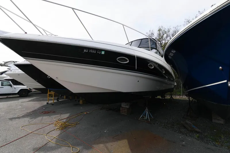 Slide: The Image of 2009 Larson Cabrio 330 Day Cruiser on a dry dock. - 2