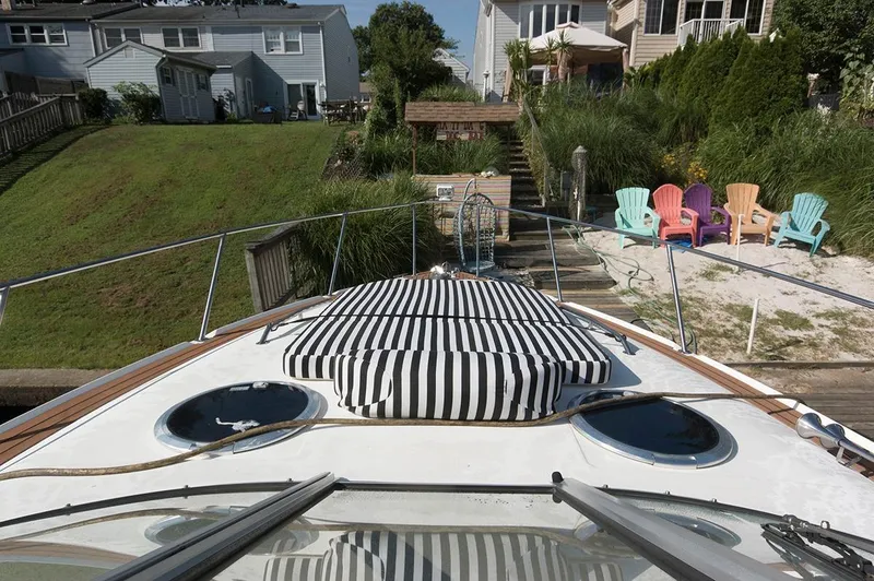 Slide: The Image of 2009 Larson Cabrio 330 Day Cruiser docked with striped sun deck. - 9