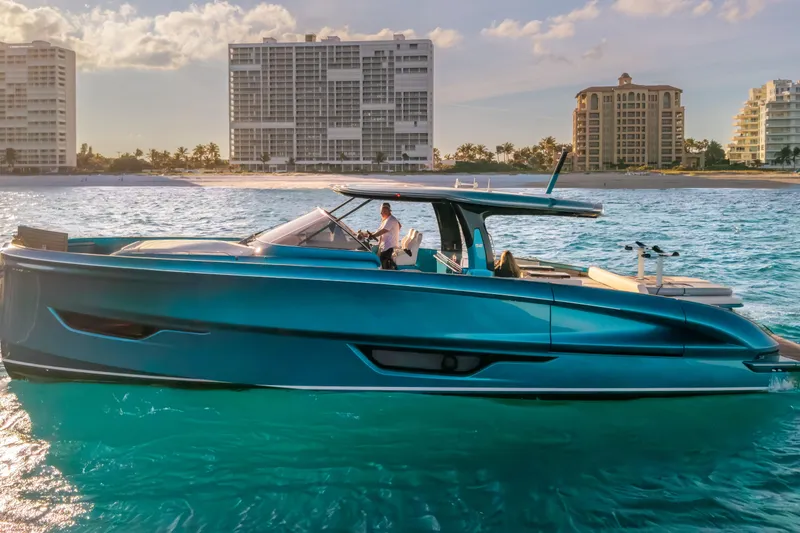 Slide: The Image of 2024 Solaris Power 52 Open yacht cruising near a coastal city skyline. - 1