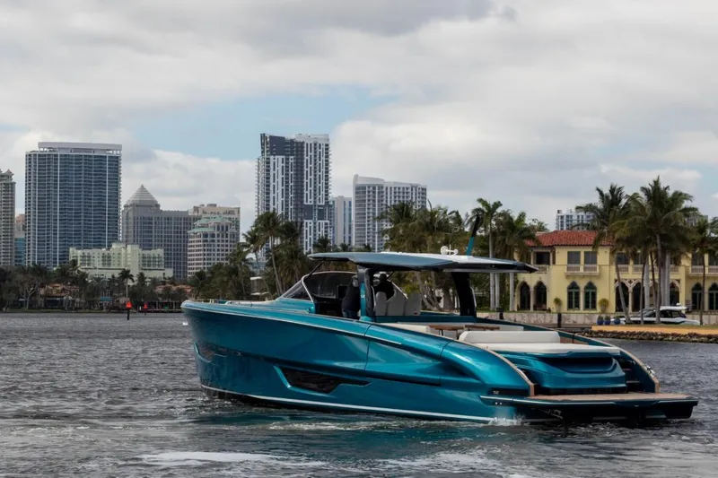 Slide: The Image of 2024 Solaris Power 52 Open yacht cruising near city skyline and waterfront homes. - 13
