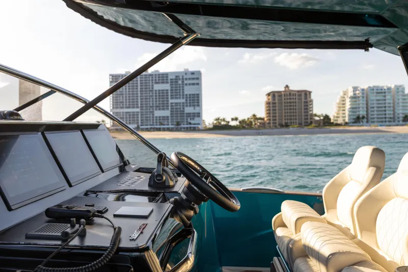 Slide: The Image of 2024 Solaris Power 52 Open yacht interior with ocean and cityscape view. - 20