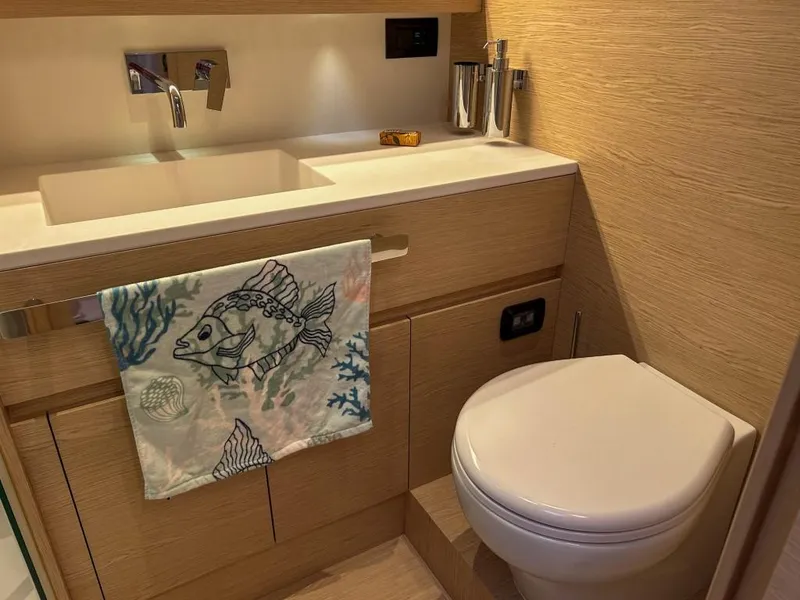 Slide: The Image of Modern bathroom in 2024 Solaris Power 52 Open yacht with sink and toilet. - 28