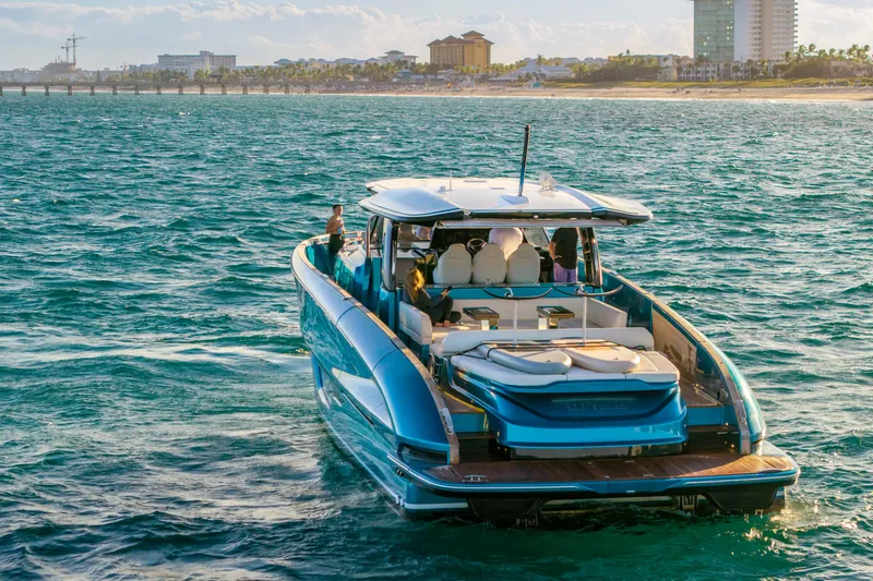 Slide: The Image of 2024 Solaris Power 52 Open yacht cruising near a coastal cityscape. - 3