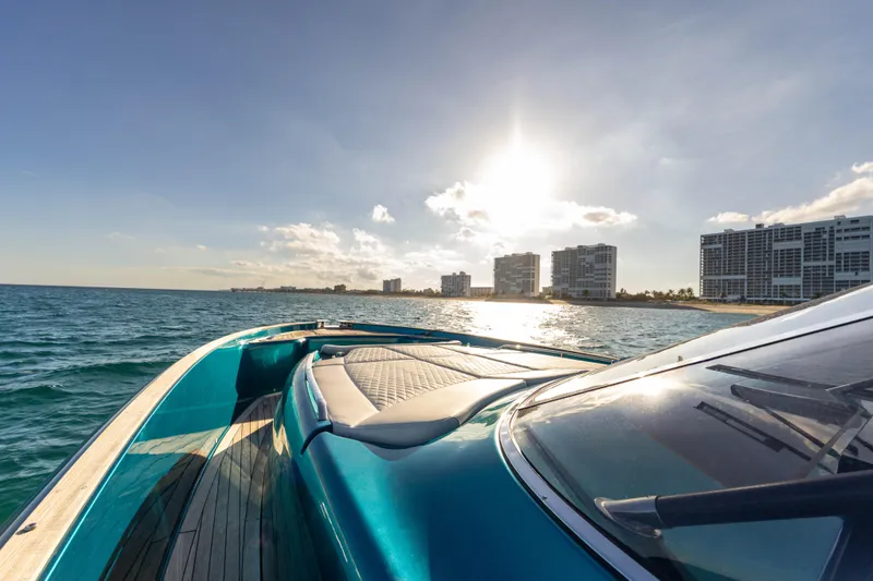 Slide: The Image of 2024 Solaris Power 52 Open yacht cruising near coastal city skyline at sunset. - 15