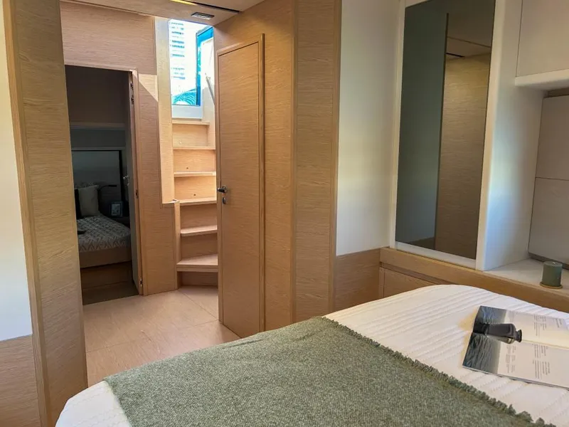 Slide: The Image of Interior cabin of 2024 Solaris Power 52 Open yacht with wooden finishes and cozy bedding. - 26