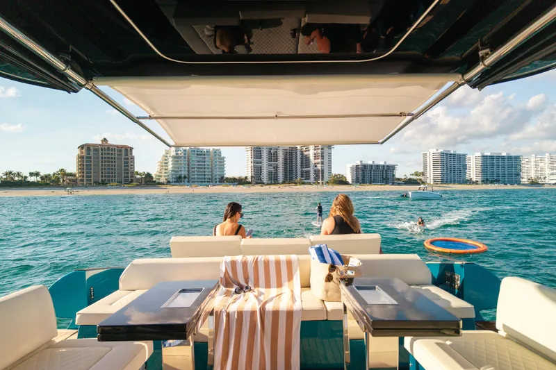 Slide: The Image of 2024 Solaris Power 52 Open yacht with beach view, people relaxing onboard. - 35